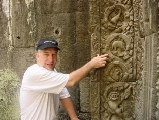 The author poses with the dinosaur bas-relief