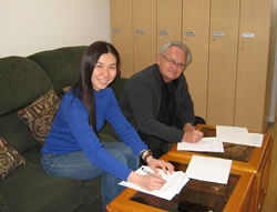 A beaming Michiko Mizumura of CRJ signs the historic agreement in Japan along with Dr. David Crandall of our staff.