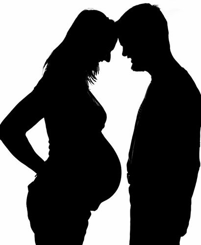 Silhouette of Pregnant Woman and Her Husband