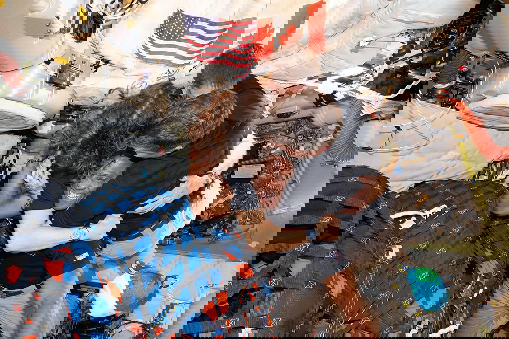 Space crew group hugging