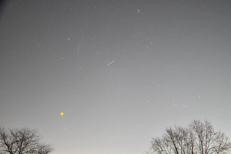 Short, upward-moving meteor is to the lower right of Capella.