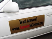 Answers in Genesis advertisement on a car door