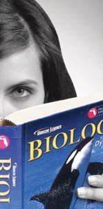 Girl reading biology textbook