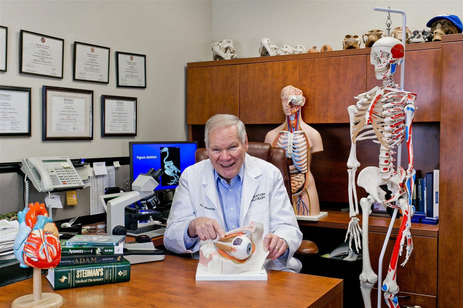 Dr. Menton sitting in his office.