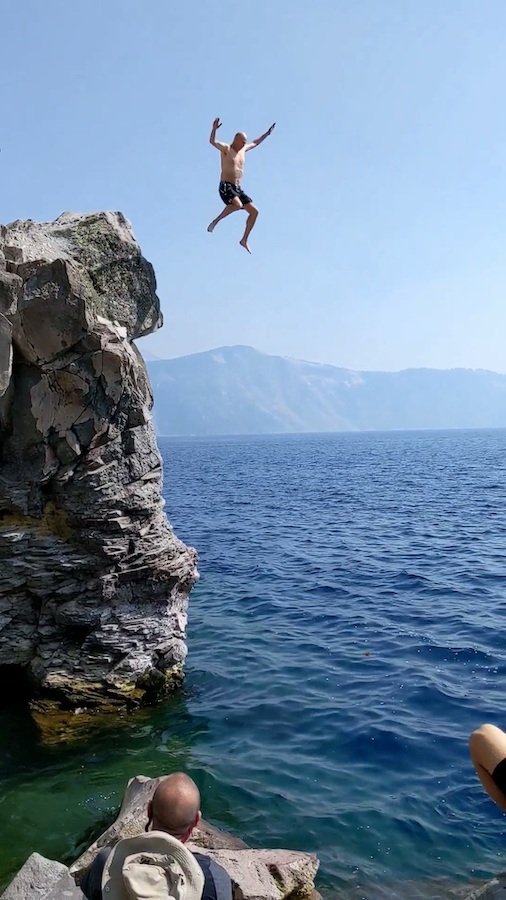 Tim Chaffey jumping off a large rock into water
