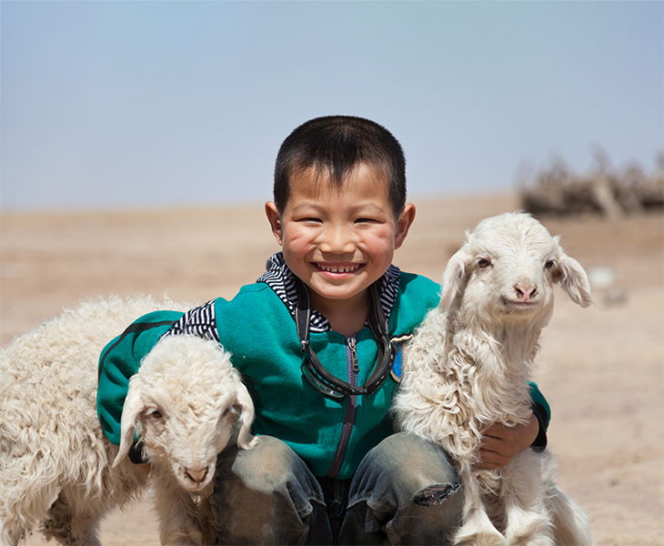 A boy with a lamb.