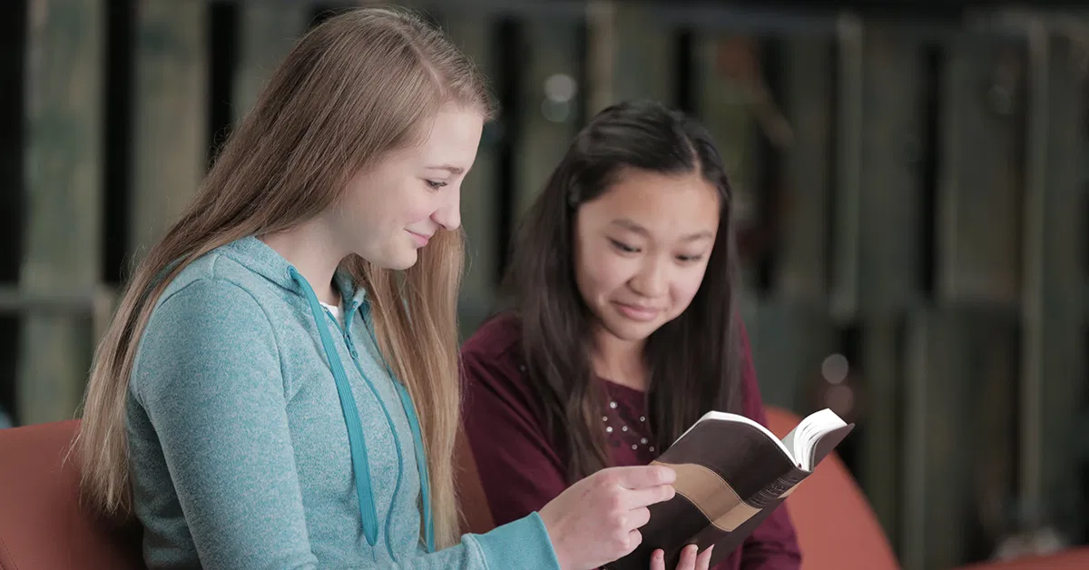 Two girls with a Bible