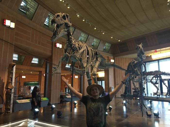 Kyle standing in front of Elvis the Torvosaurus