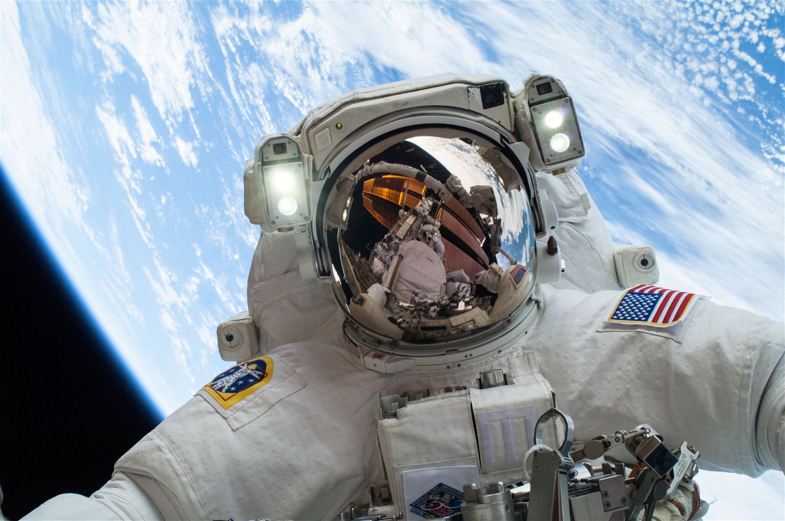 Astronaut in space with earth behind them.