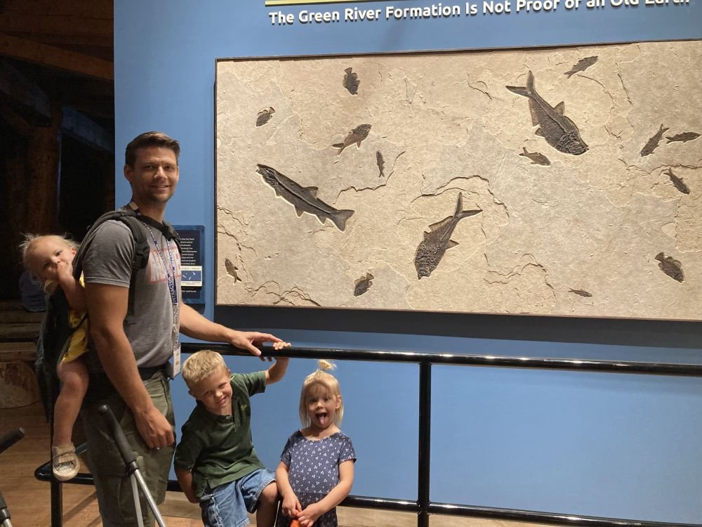 Trevor and the children in front of the fossilized fish exhibit at the Ark Encounter