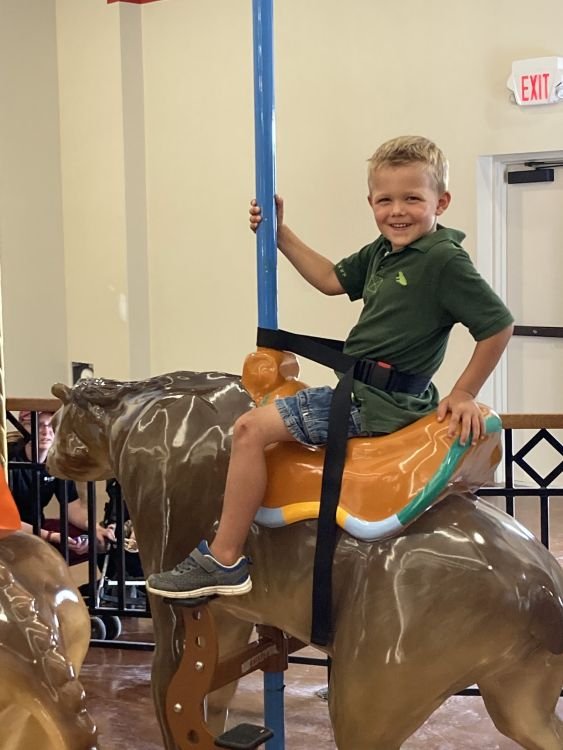 Winston rides the new carousel at the Ark Encounter
