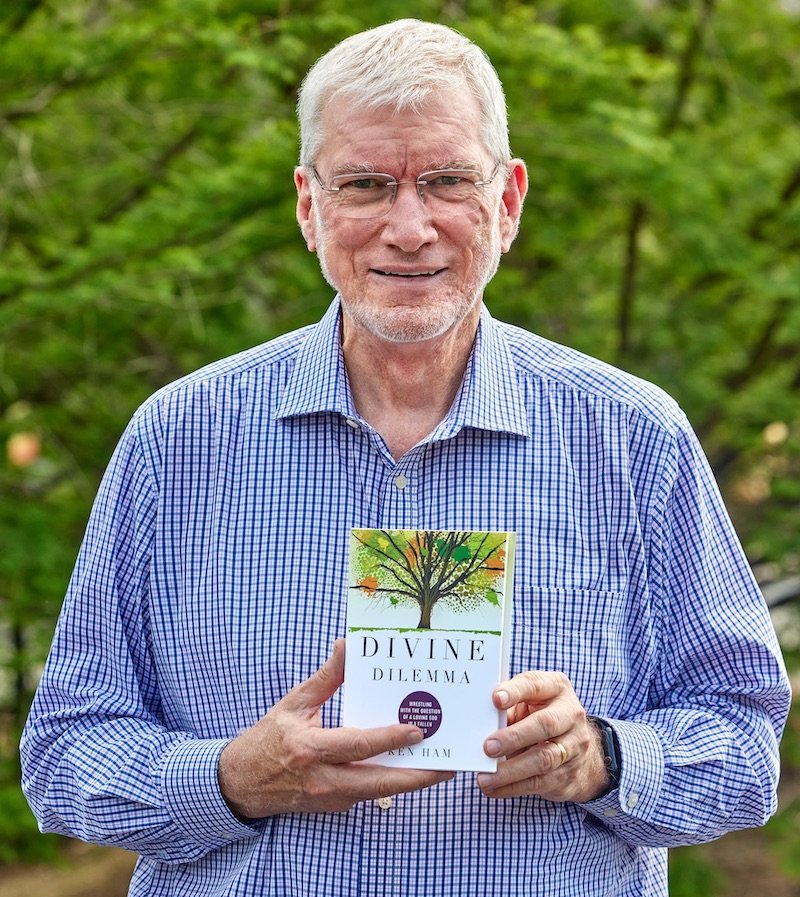 Ken holding new book Divine Dilemma