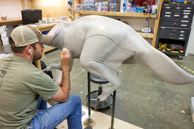 Exhibit artist working on sculpting the dinosaur’s body