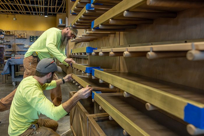 Fabrication team installing shelves