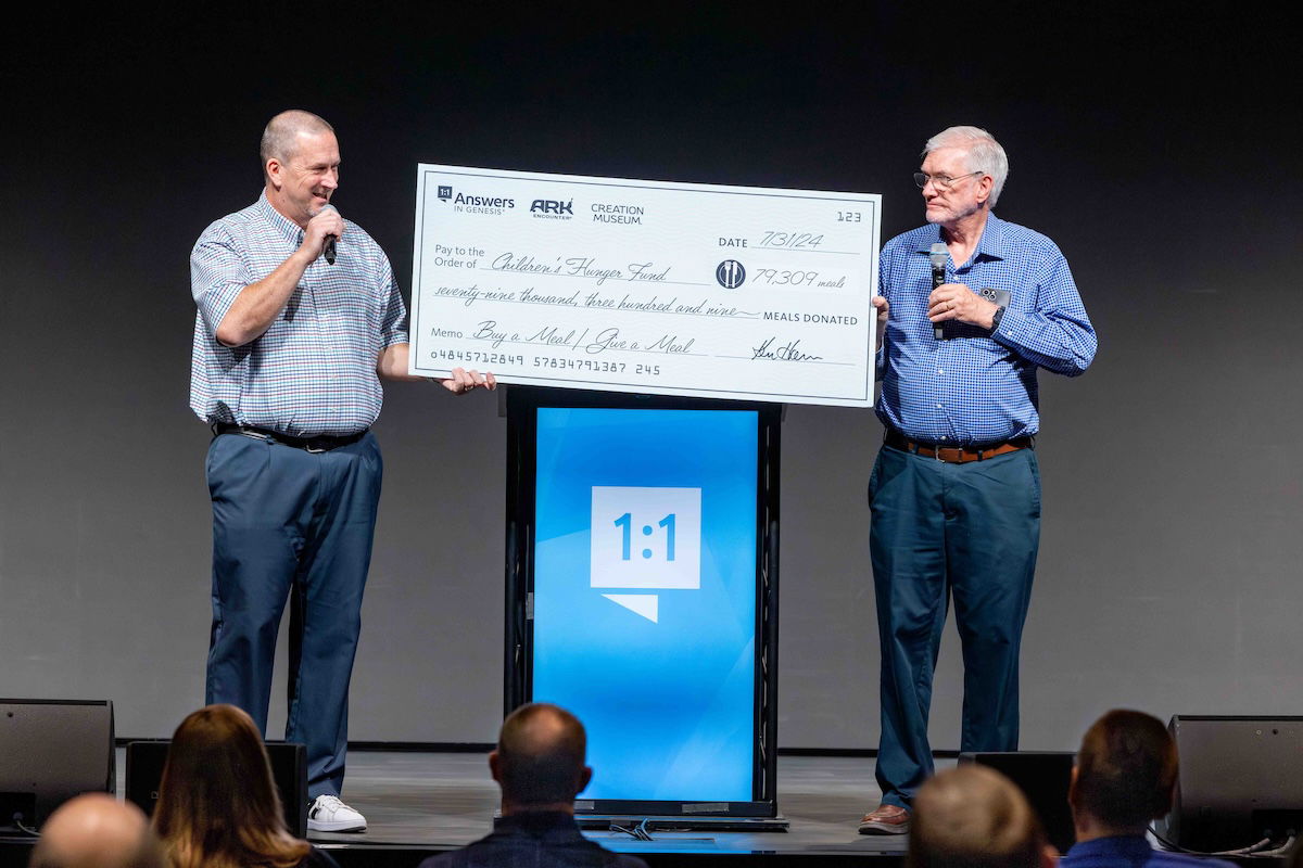 Ken presenting CHF’s Senior Vice President with a check for the meals