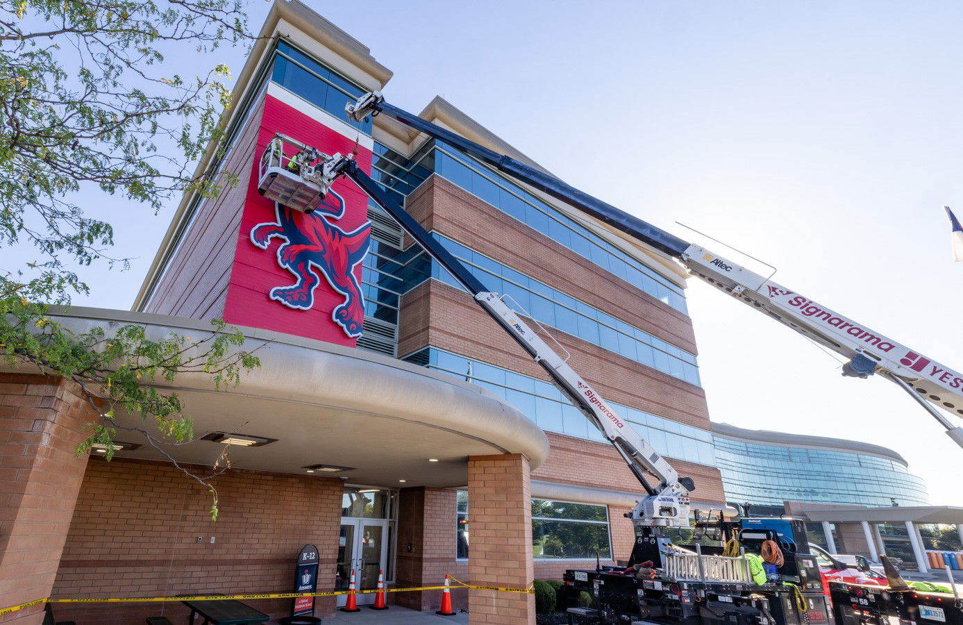 Raptor mascot sign being installed