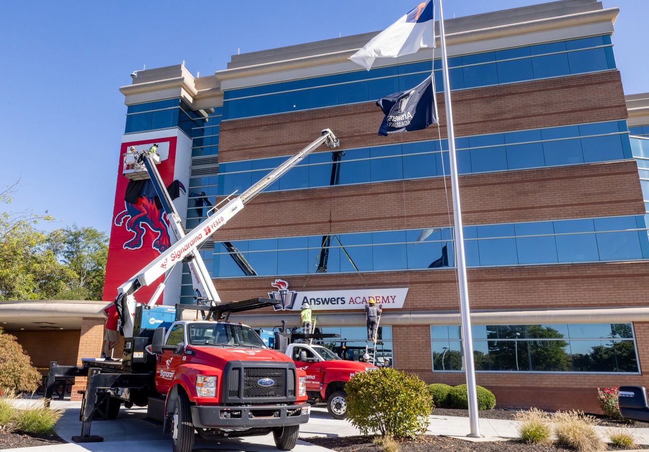 Both signs being installed