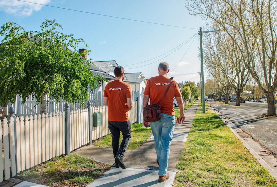 Two volunteers passing out the Gospel