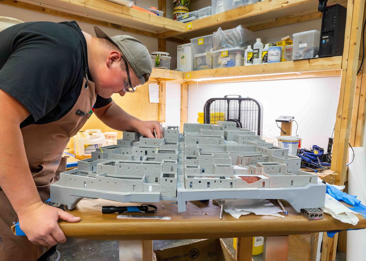 Artist assembling Jerusalem model