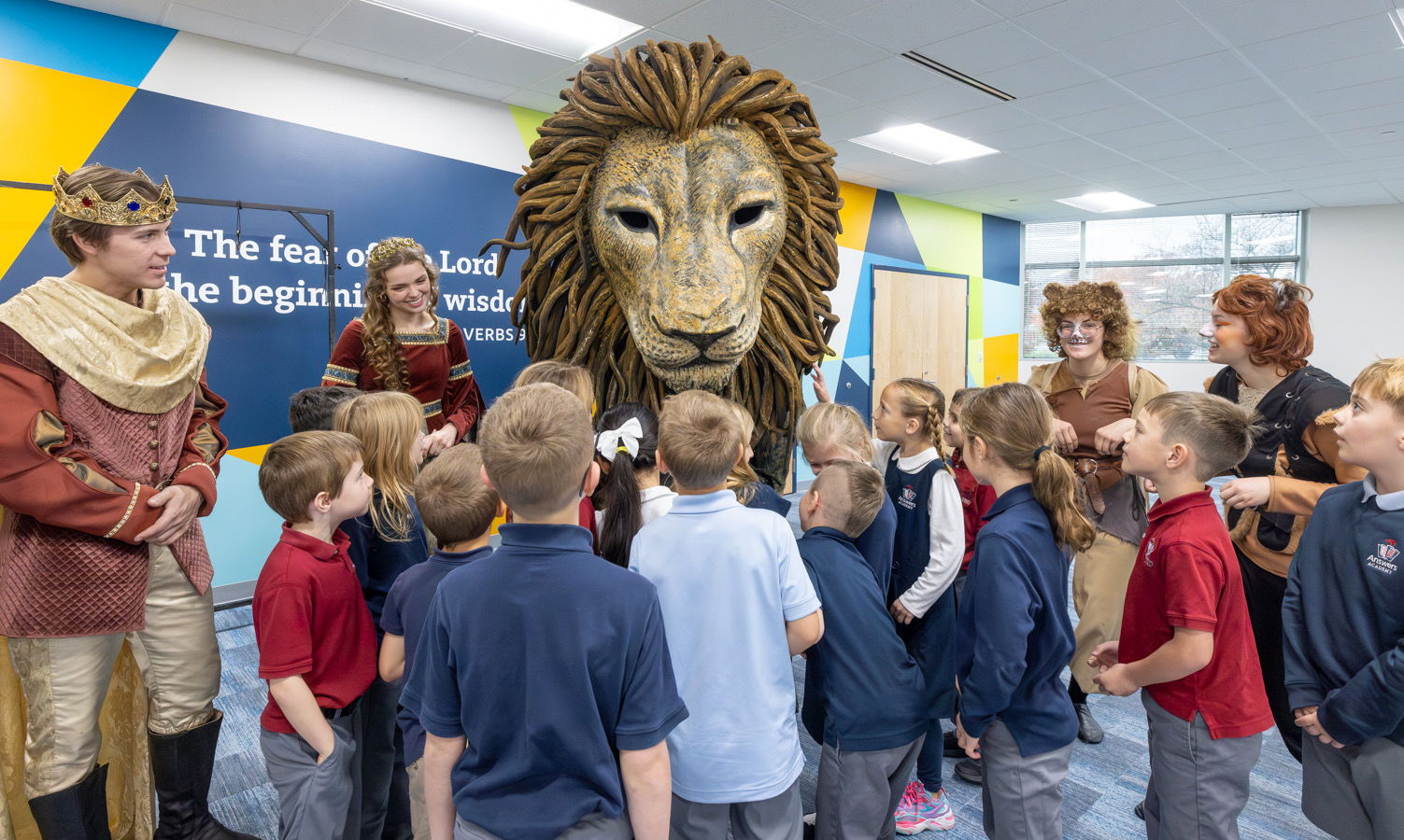 Students with life-size Aslan puppet