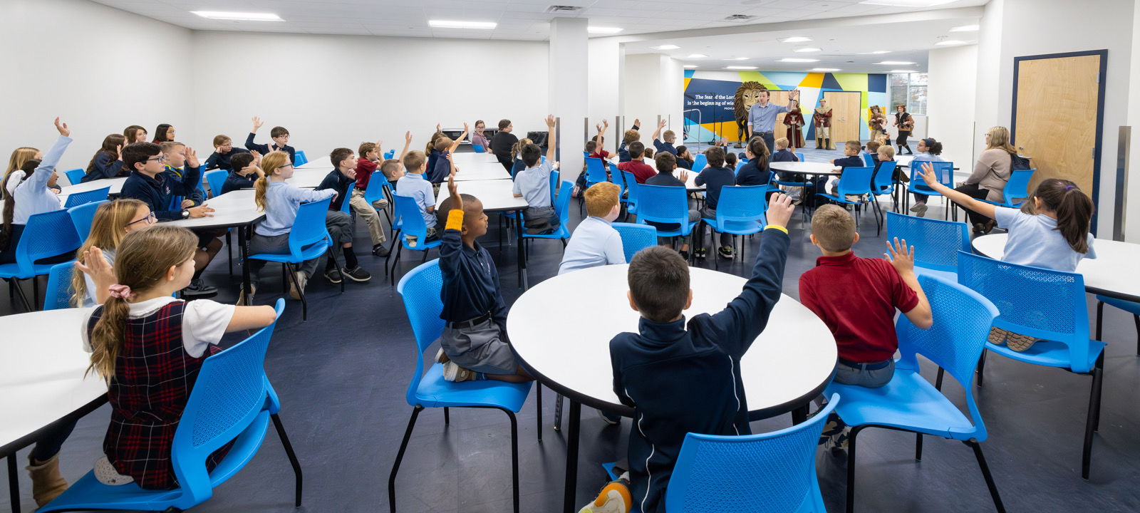 Students raising hands to answer a question