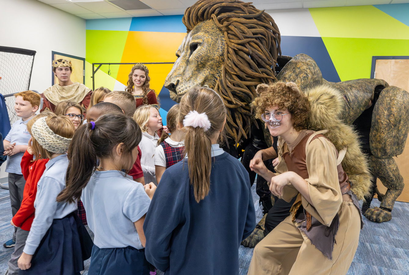 Students with cast and Aslan puppet