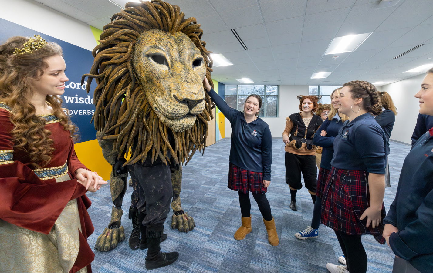 Student touching Aslan puppet