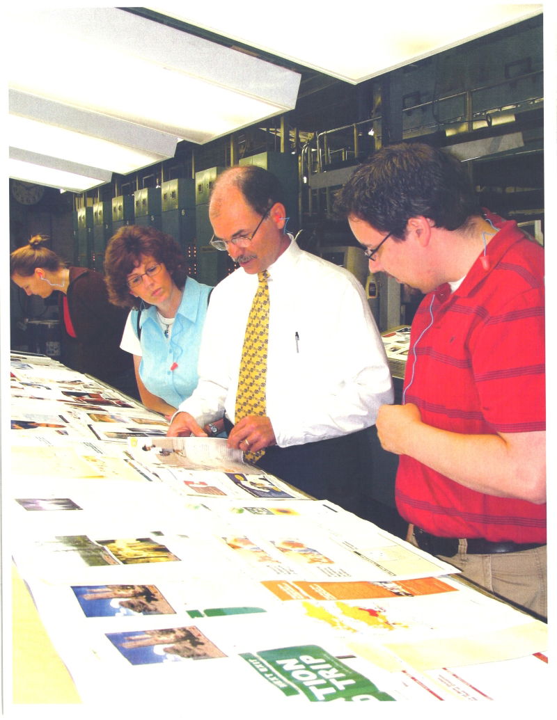 Staff members looking at magazine