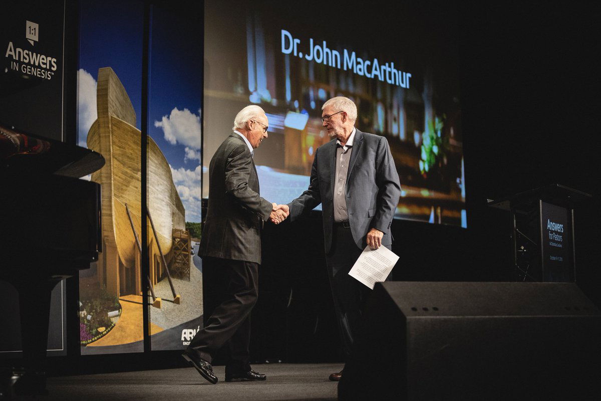 John MacArthur walking on stage