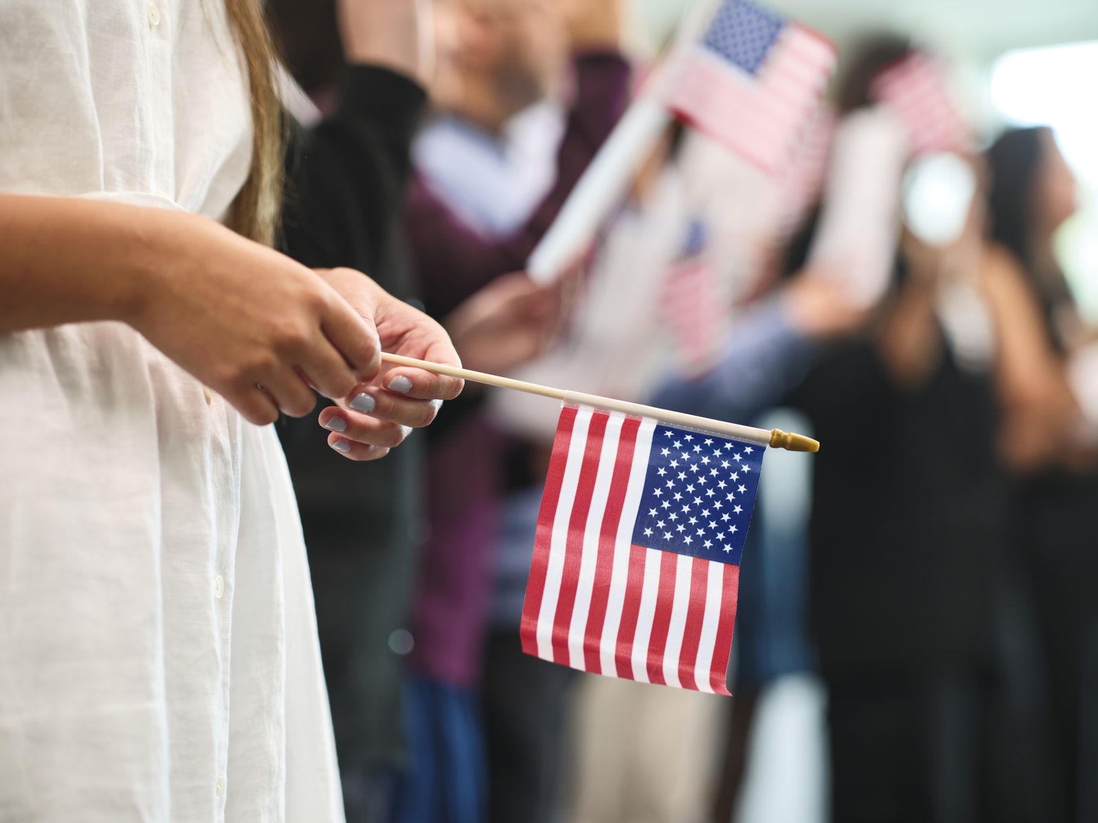woman holding small American flag