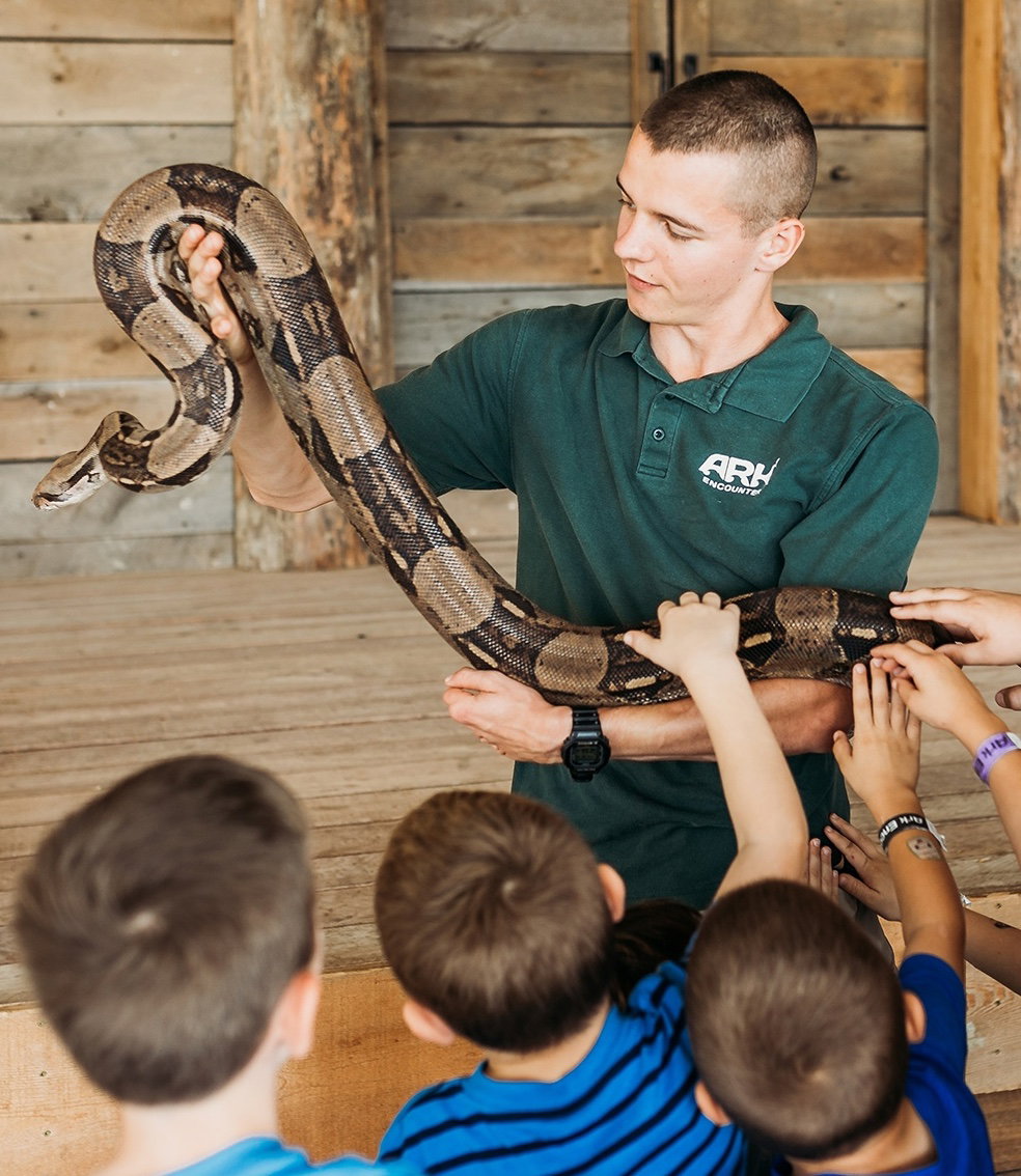 snake with zoo staff