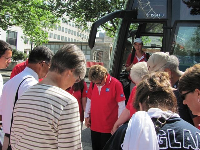 Virginia Harp leading her group in prayer before they head out for the day.