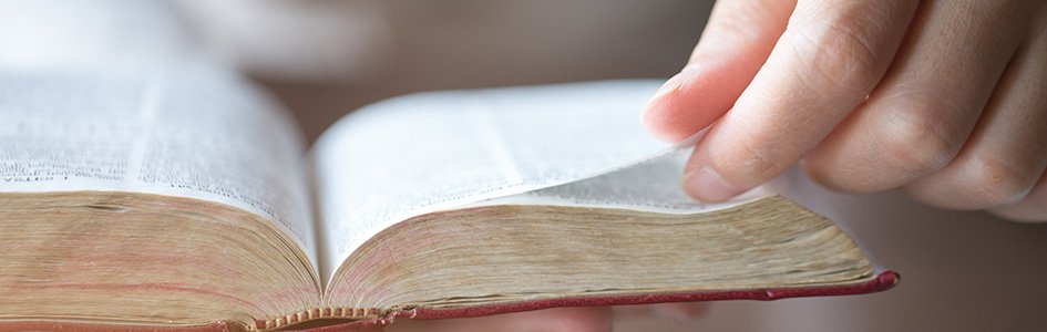 Hand Turning Bible Page