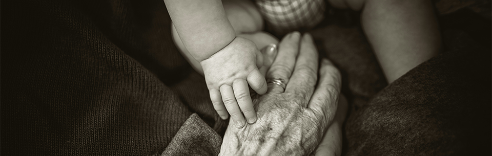 hand of a baby and of a grandparent