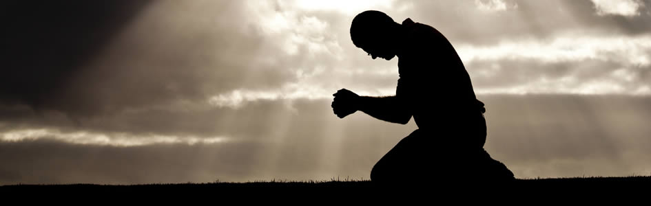 Man Kneeling in Prayer