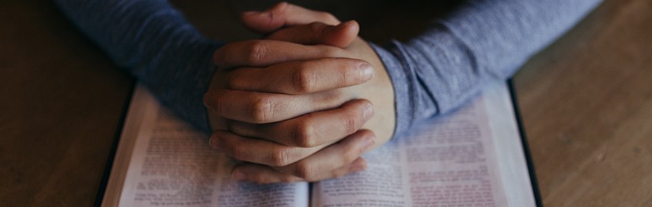 Praying over open Bible
