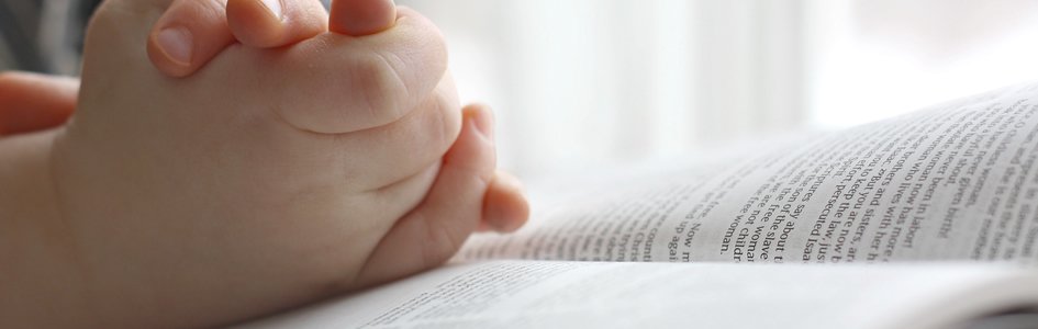Child's Hands on Bible