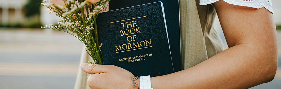 Woman holding Book of Mormon