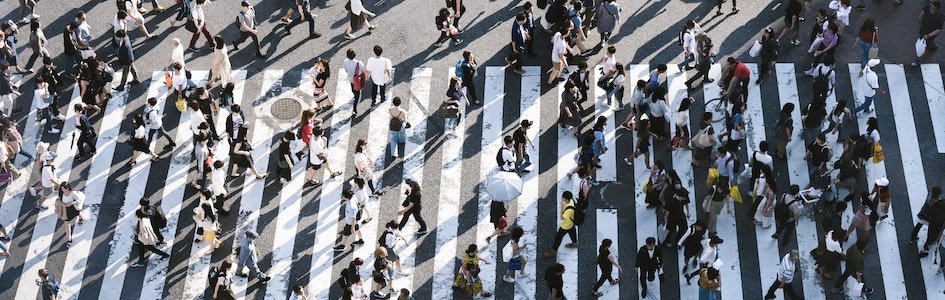 Arial view of people walking across the shibuya crossing.