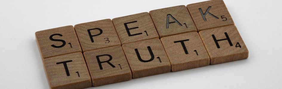 Scrabble tiles spelling "Speak Truth"