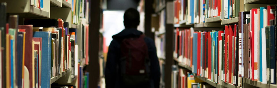 Student walking through school library