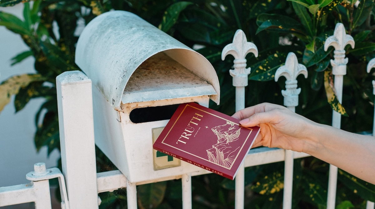 Gospel of Luke being placed in mailbox